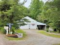 Detached two-car garage with white exterior, located on large gravel driveway at 8310 Dog Trot Ln, Morgantown, IN 46160