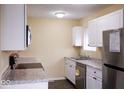 Modern kitchen with white cabinets, stainless steel appliances, and granite countertops at 8361 Paso Del Norte Ct, Indianapolis, IN 46227
