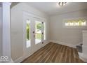 Bright entryway with new flooring, decorative window, and stylish door at 839 N Oxford St, Indianapolis, IN 46201