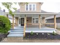 Inviting front porch with stylish railings, steps, and fresh landscaping, perfect for relaxing outdoors at 839 N Oxford St, Indianapolis, IN 46201
