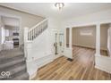 Open living space with staircase, light hardwood floors and updated finishes at 839 N Oxford St, Indianapolis, IN 46201