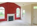 Bright living room featuring a fireplace, large windows, and neutral carpet at 855 Gazebo Way # C, Greenwood, IN 46142