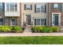 Attractive townhome exterior with tasteful landscaping and a welcoming entrance, complete with wreath at 9090 Demarest Dr, Fishers, IN 46038