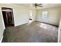 Spacious living room with neutral carpeting, a ceiling fan, and ample natural light at 910 Lonsvale Dr, Anderson, IN 46013