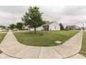Wide view of the front lawn, sidewalk, and street in front of the house at 933 Curlew Ln, Greenwood, IN 46143