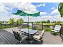 Outdoor deck with seating overlooking a pond and walking path at 9358 W Rising Sun Dr, Pendleton, IN 46064