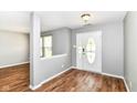 View of the front door and foyer with gray walls and wood-look flooring at 9358 W Rising Sun Dr, Pendleton, IN 46064