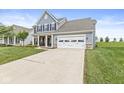 Attractive two-story home with a manicured lawn, a spacious driveway, and a charming covered porch at 10284 Legacy Dr, Brownsburg, IN 46112
