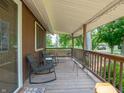 Inviting covered porch features wooden railings and comfortable seating, perfect for relaxing at 10307 Wilson Rd, Brownsburg, IN 46112