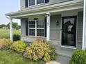 Welcoming front porch with detailed trim, and lush landscaping at 1287 Highland Lake Way, Brownsburg, IN 46112