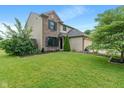 Lovely two-story home with a brick and vinyl exterior, a well-kept lawn, and an attached garage at 1408 Snead Cir, Avon, IN 46123