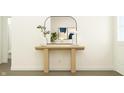 Minimalist foyer featuring a light wood console table, mirror, and stylish decor at 15395 Alperton Rd, Fishers, IN 46037