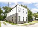 Side view of home shows landscaping, neutral paint and well maintained surrounding landscape at 1620 W New York St, Indianapolis, IN 46222