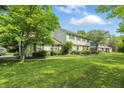 Spacious two-story house surrounded by mature trees and a well-maintained lawn at 1748 Sweet Gum Dr, Indianapolis, IN 46260