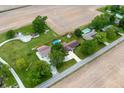 Areal view of a residential home and in-ground pool surrounded by green pastures at 1891 W 300 N, Anderson, IN 46011