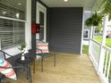 Close up of the front porch with seating and decor at 203 W 3Rd St, Sheridan, IN 46069