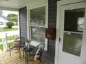 Inviting front porch with chairs, pillows, and a charming mailbox at 203 W 3Rd St, Sheridan, IN 46069