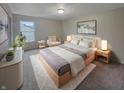 Cozy bedroom with natural light, a stylish bed, and a comfy sitting area with plants at 2035 Theodore Dr, Indianapolis, IN 46214