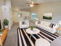 Bright living room with modern furniture, neutral walls, and a vaulted ceiling with a ceiling fan at 2035 Theodore Dr, Indianapolis, IN 46214