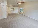 Large living room with carpet flooring, high ceilings, neutral colors, and a big window at 2035 Theodore Dr, Indianapolis, IN 46214