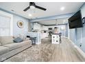 Open-concept living space with modern finishes, light blue walls, and adjoining kitchen at 2209 W 9Th St, Muncie, IN 47302
