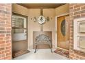 Charming entryway featuring a decorative bench, wreath, and two doors with brick accents at 2267 Rome Dr # A, Indianapolis, IN 46228