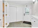 Bright foyer area featuring neutral paint, tile flooring, and a stylish front door at 2267 Rome Dr # A, Indianapolis, IN 46228