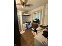 Laundry room with hardwood floor, utility sink and a window with patterned curtains at 2310 Noble St, Anderson, IN 46016