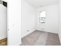 Bright, carpeted bedroom with a single window and neutral walls, ready for personalization at 2412 Peoples Dr, Indianapolis, IN 46205