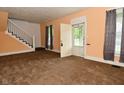 Cozy living room with neutral paint, carpet flooring, and staircase access at 2622 Ethel Ave, Indianapolis, IN 46208