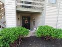 Charming entryway with lush green bushes framing a decorative wreath on the front door at 2931 Eagles Crest Cir, Indianapolis, IN 46214