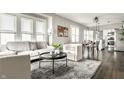 Bright, open-concept living room with plush seating, large windows, and stylish decor, perfect for relaxation at 3764 Ruckle St, Indianapolis, IN 46205