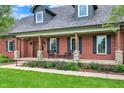 Welcoming front porch featuring brick columns and comfortable seating, perfect for enjoying the outdoors at 4123 S Village Row, New Palestine, IN 46163
