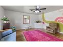 Bright living room featuring hardwood floors, a unique wall design, and a window at 4125 Bowman Ave, Indianapolis, IN 46227