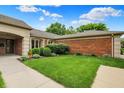 Brick home with manicured green lawn and neatly trimmed shrubs enhancing curb appeal at 423 Bent Tree Ln, Indianapolis, IN 46260
