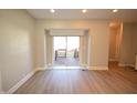 Bright living space featuring sliding glass doors to outdoor wooden deck area and neutral paint at 4231 Carrollton Ave, Indianapolis, IN 46205