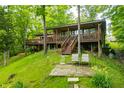 Charming lake house with a large deck, offering a peaceful retreat surrounded by nature and lush greenery at 429 E Hoover Dr, Nineveh, IN 46164