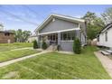 Charming single-story home featuring a manicured front yard with an inviting walkway and covered porch at 441 N Temple Ave, Indianapolis, IN 46201