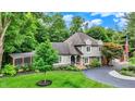 Inviting two-story home with stone accents, a screened porch, and a circular driveway at 4623 E Windsor Ln, Columbus, IN 47201