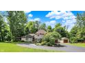 Two-story home features a circular driveway, manicured landscaping, and an American flag at 4623 E Windsor Ln, Columbus, IN 47201