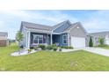 View of the blue, one-story home featuring a welcoming front porch, well-maintained lawn, and tidy landscaping at 485 Thunderwood Dr, Greenfield, IN 46140