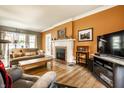 Comfortable living room features a fireplace, hardwood floors, and large picture window at 4912 Central Ave, Indianapolis, IN 46205