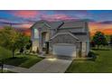 Stunning home exterior at twilight, showcasing elegant brickwork, an attached garage, and landscaped front yard at 515 Lynton Way, Westfield, IN 46074