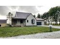 Charming two-story home featuring a metal roof and an attached two car garage at 6593 N 800 W, Elwood, IN 46036