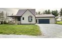 Charming two-story home featuring a metal roof and an attached two car garage at 6593 N 800 W, Elwood, IN 46036