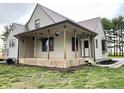Charming two-story home featuring a metal roof and inviting porch with flower baskets at 6593 N 800 W, Elwood, IN 46036