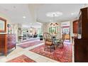 Spacious dining room with tile flooring, stylish rug, and a modern glass dining table at 6760 Spirit Lake Dr # 201, Indianapolis, IN 46220