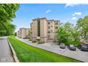 An attractive residential building with a manicured lawn is nestled in lush greenery at 6760 Spirit Lake Dr # 11, Indianapolis, IN 46220