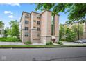 Charming exterior of building showing brick and stucco facade, glass atrium and well-maintained landscaping at 6760 Spirit Lake Dr # 11, Indianapolis, IN 46220