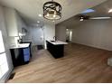 Stylish kitchen featuring an island, modern lighting, and seamless flow into the living area at 6845 Arjay Dr, Indianapolis, IN 46217